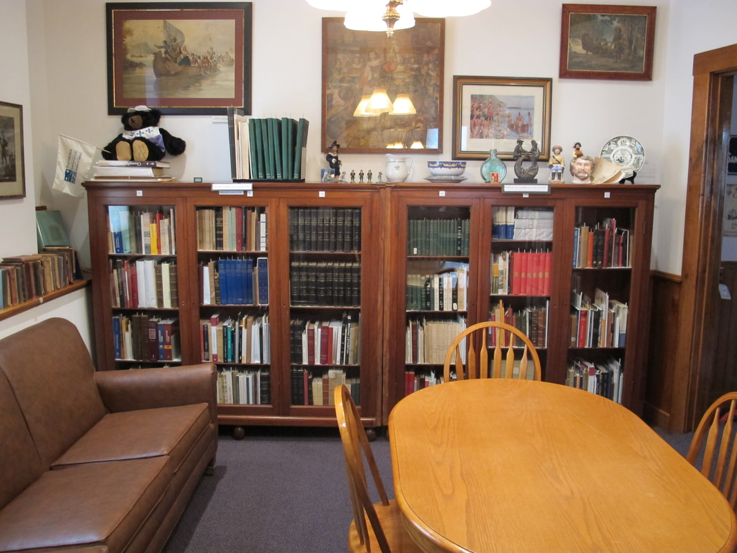 Franco-American Collection publications shelves in glass front bookcases